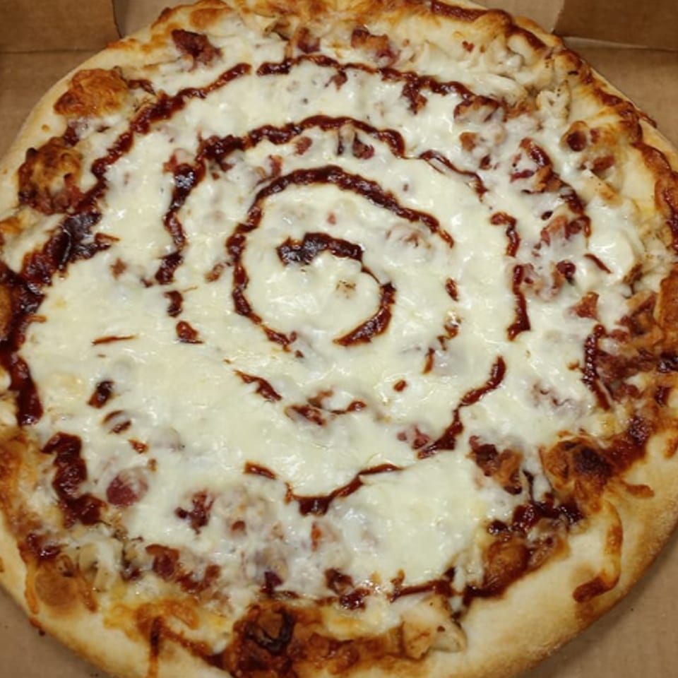 Venice Pizza's BBQ chicken pizza with a swirl of barbecue sauce over melted mozzarella cheese.